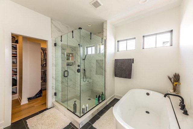 bathroom featuring independent shower and bath