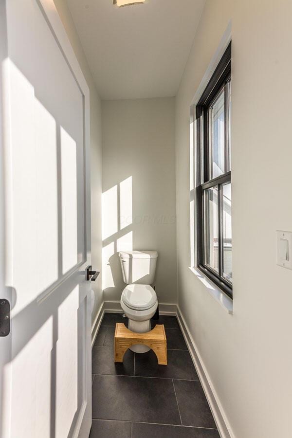 bathroom featuring tile patterned flooring and toilet