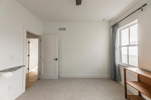 empty room featuring light colored carpet