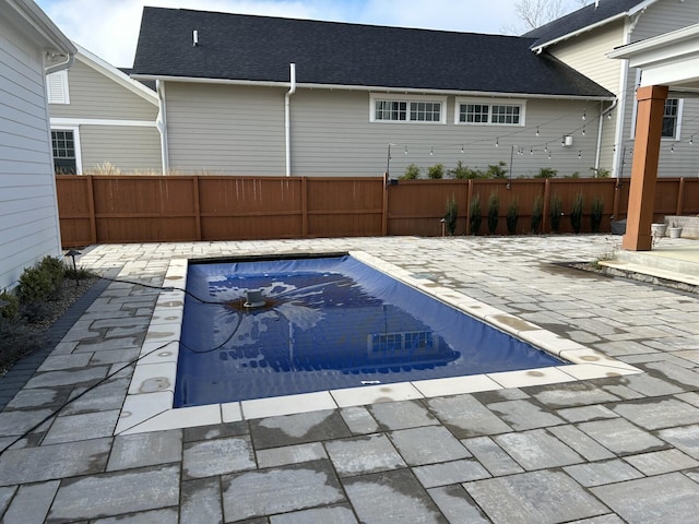 view of pool with a patio area, fence, and a fenced in pool