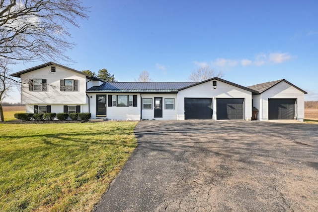 split level home with a front yard and a garage