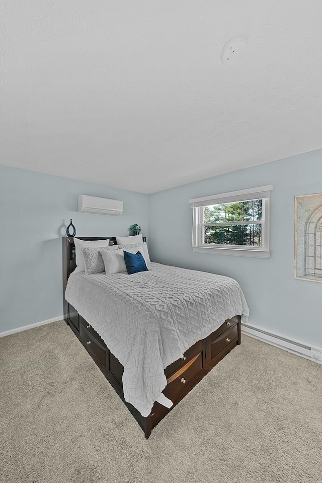 bedroom with an AC wall unit, a baseboard heating unit, and light carpet