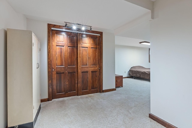 hallway with light colored carpet