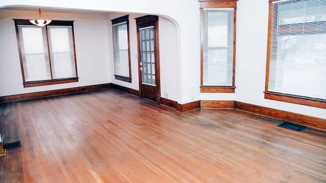 unfurnished room with dark hardwood / wood-style flooring