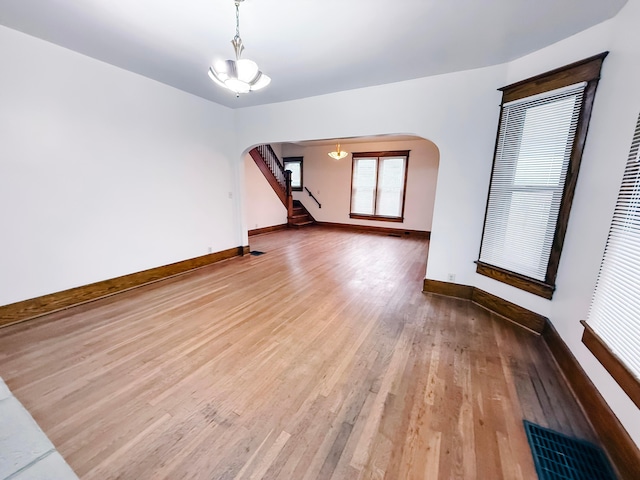 interior space with a notable chandelier and hardwood / wood-style flooring