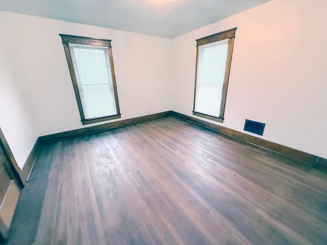 empty room featuring dark wood-type flooring