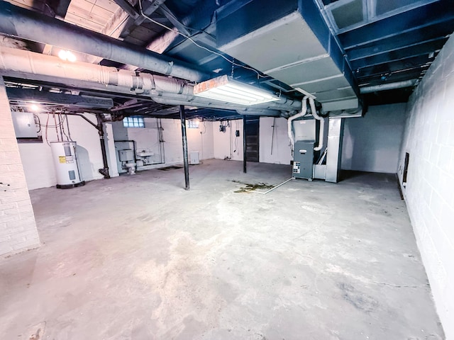 basement with electric water heater and heating unit