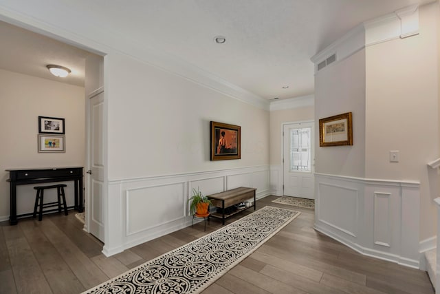 corridor featuring ornamental molding and hardwood / wood-style floors