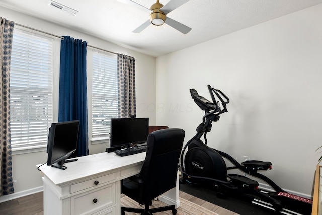 home office with ceiling fan, hardwood / wood-style floors, and a wealth of natural light