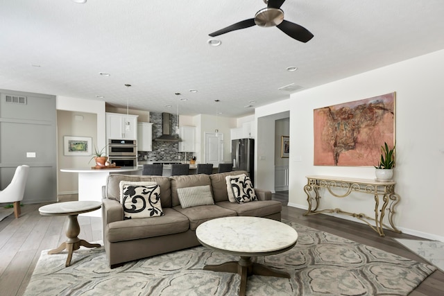 living room featuring hardwood / wood-style flooring and ceiling fan