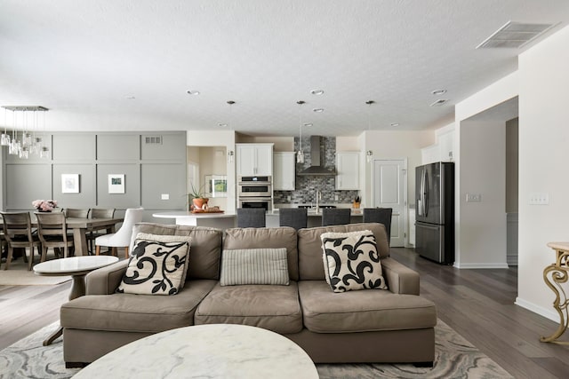 living room with sink and dark hardwood / wood-style floors