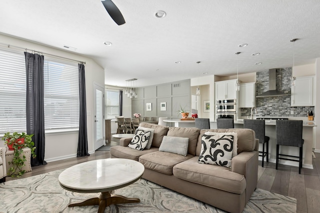 living room featuring ceiling fan and dark wood-type flooring