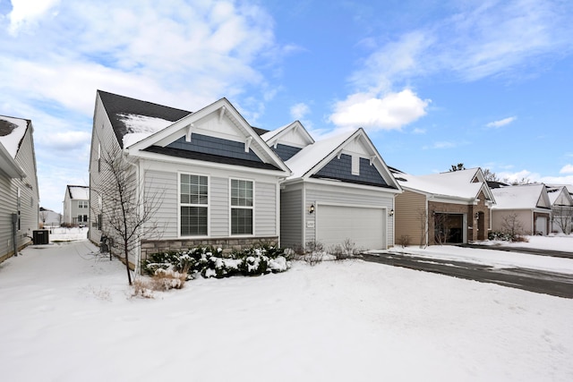 view of front of property featuring central AC unit and a garage