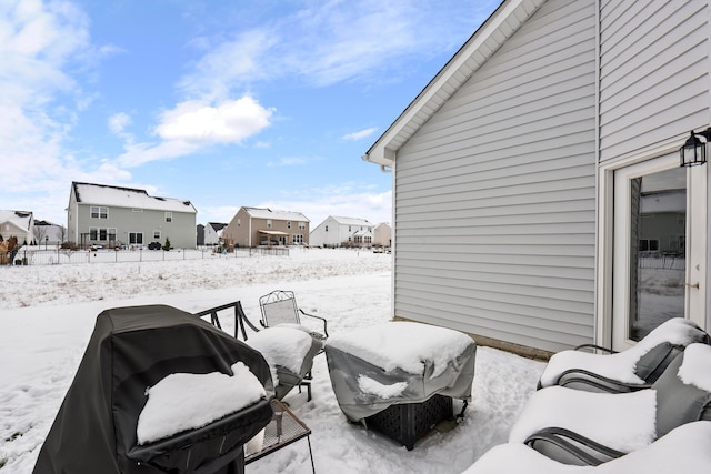 snow covered patio with area for grilling