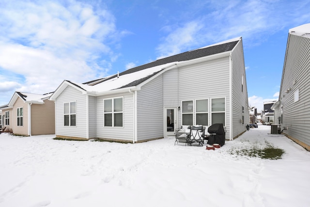 view of snow covered rear of property