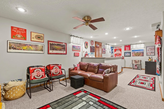 carpeted living room featuring a textured ceiling and ceiling fan