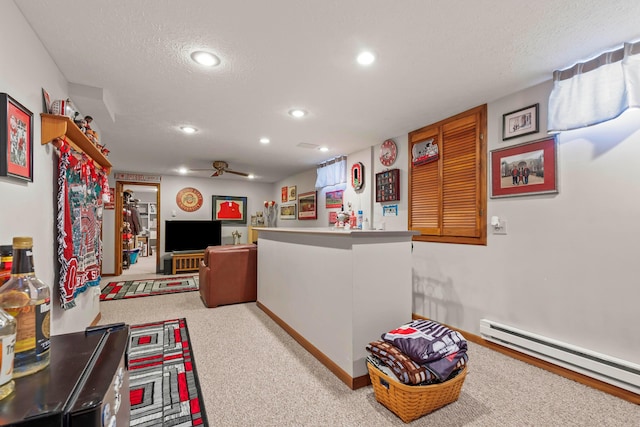 interior space featuring a baseboard heating unit, light carpet, and a textured ceiling