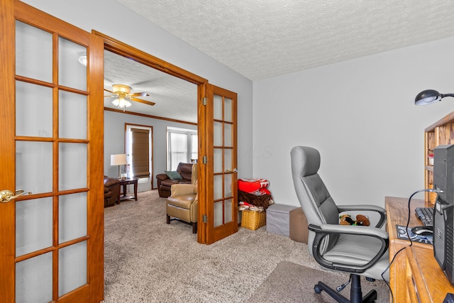 carpeted office space with a textured ceiling, ceiling fan, french doors, and crown molding