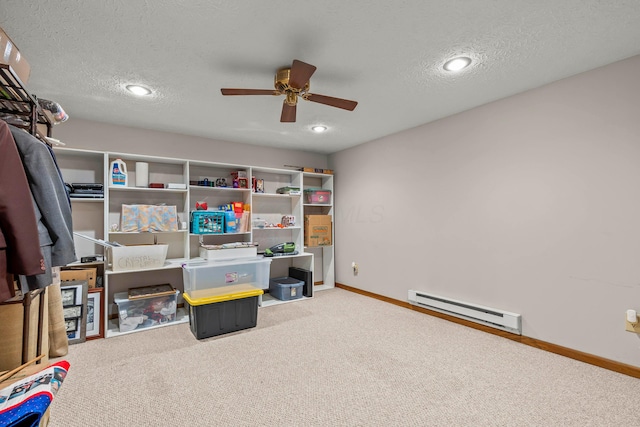 office space featuring light carpet, a textured ceiling, baseboard heating, and ceiling fan