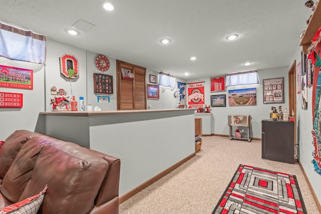 bar featuring a textured ceiling and light carpet