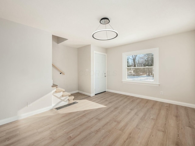 unfurnished room featuring light hardwood / wood-style floors