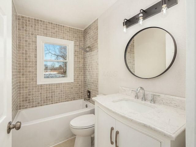 full bathroom featuring toilet, tile patterned flooring, tiled shower / bath, and vanity