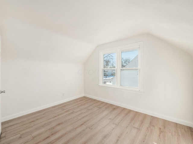 bonus room featuring light wood-type flooring and vaulted ceiling