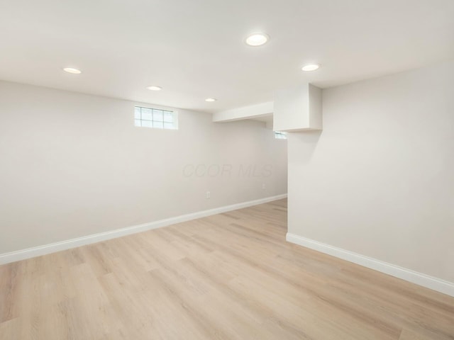 basement with light hardwood / wood-style floors