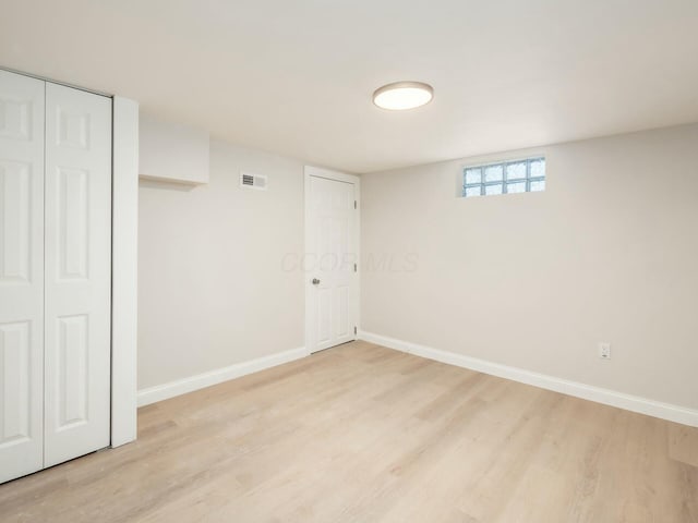 basement with light hardwood / wood-style floors