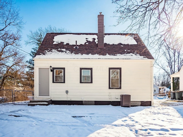 snow covered house with cooling unit