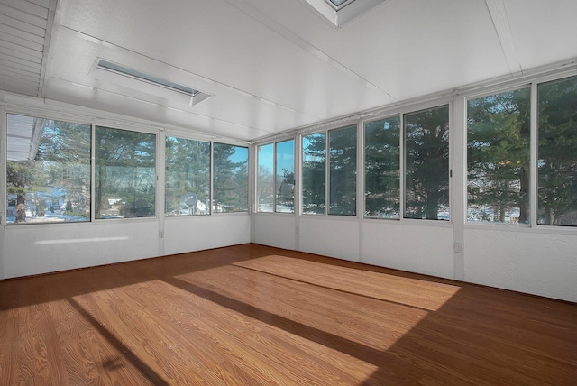 unfurnished sunroom featuring vaulted ceiling