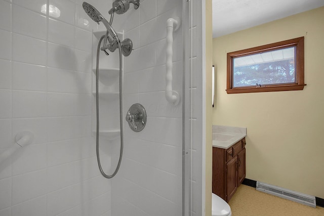 bathroom featuring tiled shower, vanity, and toilet