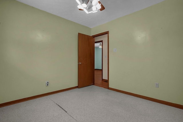 carpeted spare room with ceiling fan