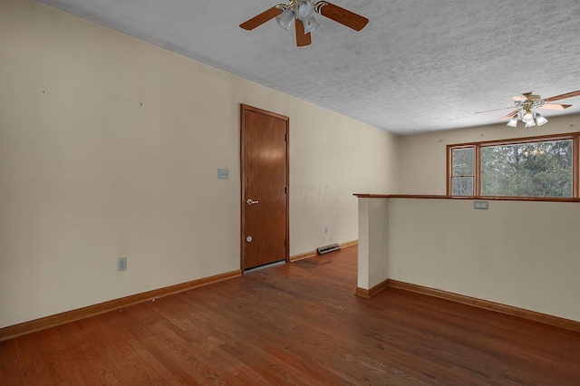 unfurnished room featuring a textured ceiling, ceiling fan, and dark hardwood / wood-style flooring