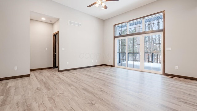 empty room with ceiling fan and light wood-type flooring