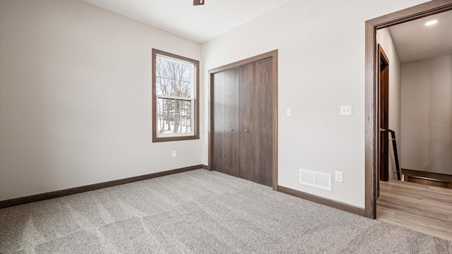 unfurnished bedroom with a closet and carpet