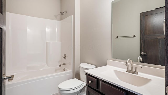full bathroom with bathtub / shower combination, vanity, and toilet