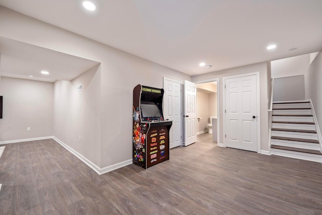 basement with dark hardwood / wood-style floors