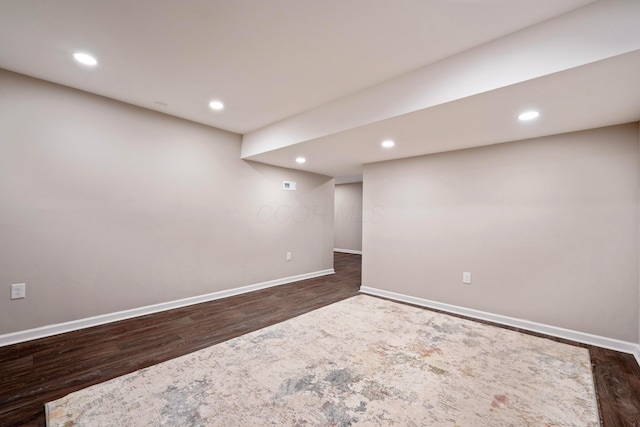 basement featuring dark hardwood / wood-style flooring