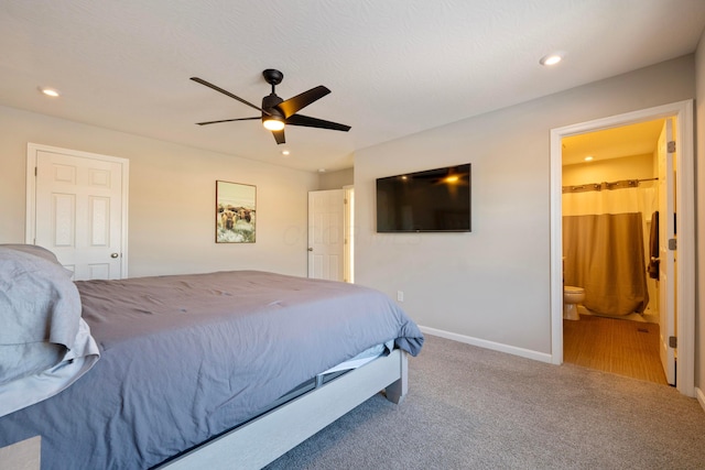 carpeted bedroom featuring ensuite bath and ceiling fan