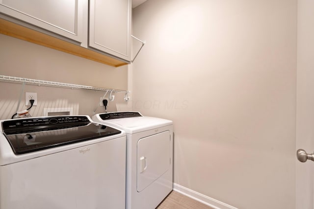 washroom with cabinets and independent washer and dryer