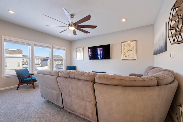 living room featuring ceiling fan and carpet