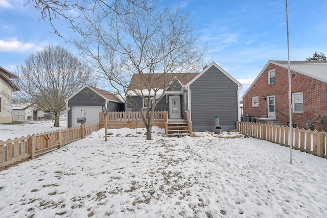 view of snow covered rear of property