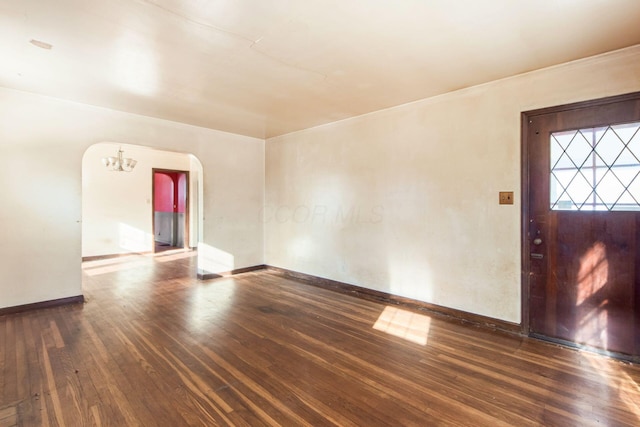 entryway featuring a chandelier and dark hardwood / wood-style floors