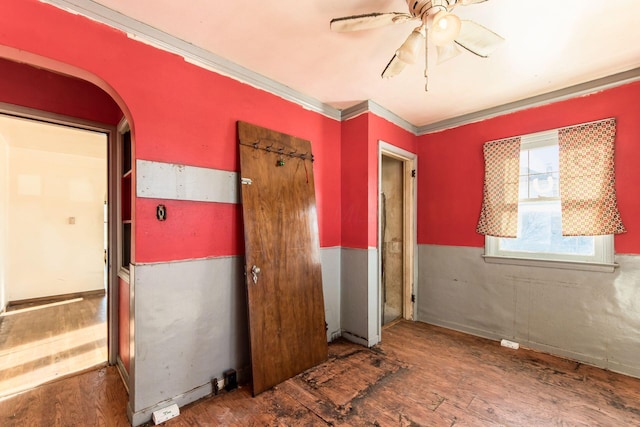 interior space with ceiling fan, crown molding, and dark hardwood / wood-style floors