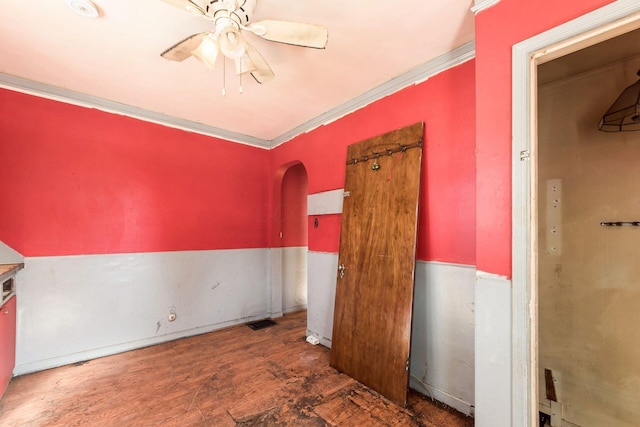 spare room with ceiling fan, ornamental molding, and dark hardwood / wood-style flooring