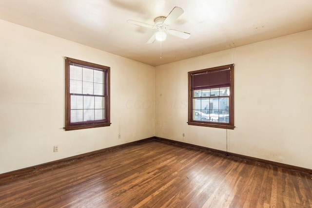 unfurnished room with dark hardwood / wood-style flooring and ceiling fan