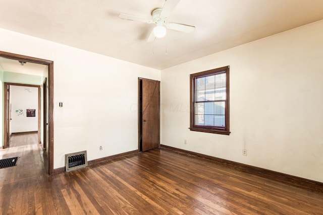 spare room with ceiling fan and dark hardwood / wood-style floors