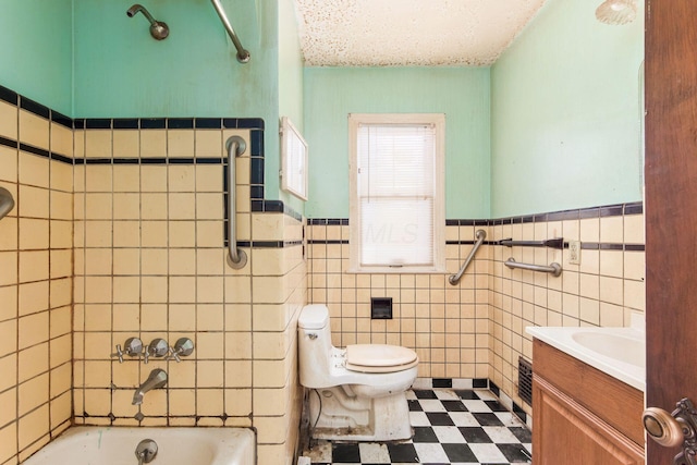 full bathroom featuring toilet, a textured ceiling, tile walls, shower / bath combination, and vanity