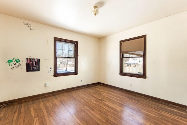 spare room with dark hardwood / wood-style floors